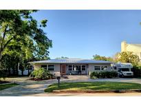Charming single-story home with a neatly manicured lawn, inviting front porch, and a paved driveway at 3217 W Lawn Ave, Tampa, FL 33611