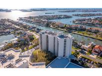 Stunning aerial view of a high-rise condo complex nestled along the waterfront, showcasing its prime location and beautiful surroundings at 5950 Pelican Bay S Plz # 603, Gulfport, FL 33707