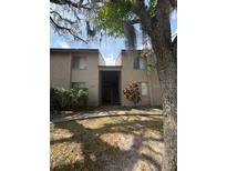 Inviting exterior featuring a two-story facade, well-maintained landscaping, and an accessible entrance at 7506 Presley Pl # 108, Tampa, FL 33617