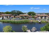 Waterfront condos featuring docks, manicured landscaping, and assigned parking at 10216 Seminole Island Dr, Largo, FL 33773
