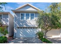 Charming two-story home featuring a two-car garage and beautifully landscaped front yard at 2837 Bayshore Trails Dr, Tampa, FL 33611