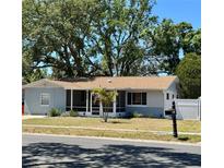 Charming single-story home featuring a screened porch and well-maintained front yard at 8766 91St St, Seminole, FL 33777