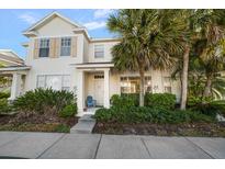 Charming two-story townhouse with lush landscaping, a quaint front porch, and neutral exteriors at 12346 Country White Cir, Tampa, FL 33635