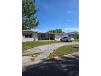 Charming single-story home with a covered porch, driveway, and well-manicured lawn at 1448 Lemon St, Clearwater, FL 33756