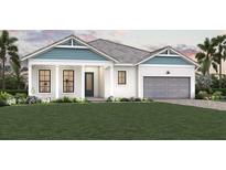 Charming single-story home featuring a two-car garage, manicured lawn, and a welcoming front porch at 18057 Foxtail Loop, Venice, FL 34293