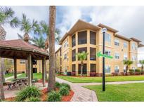 Beautiful exterior of the condo building with well-manicured landscaping and a gazebo at 4323 Bayside Village Dr # 229, Tampa, FL 33615