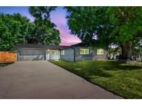 Charming single-story home with a well-manicured lawn and long driveway leading to the attached garage at 5907 Tampa Shores Blvd, Tampa, FL 33615