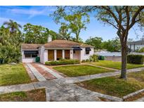 Charming single-story home featuring a well-manicured lawn and brick-paved driveway at 2925 W Alline Ave, Tampa, FL 33611