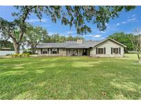 Charming single-story home with stone accents, black shutters, and a spacious front yard at 1204 Joe Henry Wheeler Dr, Dover, FL 33527
