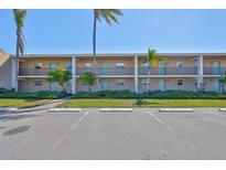 Multi-Gathering building with reserved parking and manicured landscaping under a bright blue sky at 12300 Park Blvd # 202, Seminole, FL 33772