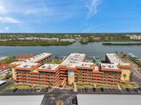 Panoramic aerial view of Bay Mariner condos, showcasing waterfront location and lush landscaping under a clear blue sky at 19701 Gulf Blvd # 210, Indian Shores, FL 33785