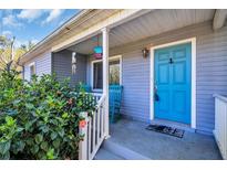 Inviting front porch with a bright blue door and comfortable rocking chairs, perfect for relaxing outdoors at 2700 56Th S St, Gulfport, FL 33707
