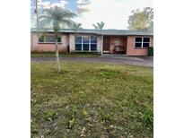Charming single-story home with a palm tree and unique stone accents on the facade at 3005 W 18Th W Ave, Bradenton, FL 34205