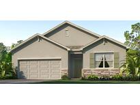 Charming single-story home featuring a two-car garage and stone accents at 3024 Living Coral St, Wimauma, FL 33598