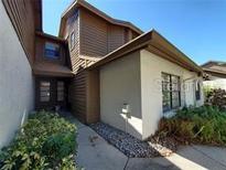 Charming two-story exterior with wood siding and well-maintained landscaping welcomes you home at 321 Parkside Ln, Safety Harbor, FL 34695