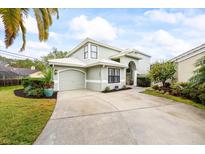 Charming home featuring a two-car garage, neutral paint, and a well-manicured lawn at 400 Westborough Ln, Safety Harbor, FL 34695