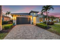 Charming single-Gathering home featuring a brick driveway and a meticulously maintained, landscaped front yard at 1110 Overlook Ct, Bradenton, FL 34208