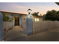 Inviting single-story home featuring a well-maintained lawn and a decorative fence at 1318 Moreland Dr # 108, Clearwater, FL 33764