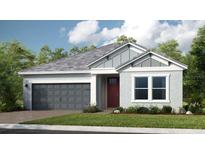 Charming single-story home featuring a gray garage door, stylish red front door, and well-manicured lawn at 1702 Trailhead Ln, Zephyrhills, FL 33541