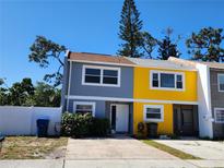 Charming two-story townhouse with a colorful facade and well-maintained landscaping, creating a welcoming curb appeal at 2930 S Pines Dr # 109, Largo, FL 33771