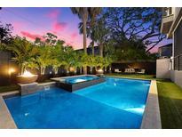 Backyard features a refreshing pool, spa, and fire pit, perfect for relaxing evenings and elegant entertaining at 3105 S Schiller St, Tampa, FL 33629