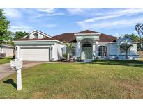 Charming one-story home with a well-manicured lawn and decorative front door at 3208 Stevenson St, Plant City, FL 33566