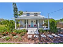 Charming home with a welcoming front porch, swing, and beautiful landscaping at 609 4Th Sw Ave, Ruskin, FL 33570
