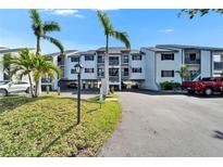 Beautiful condo complex with tropical landscaping, covered parking, and balconies on multiple levels at 803 Bahia Del Sol Dr # 66, Ruskin, FL 33570