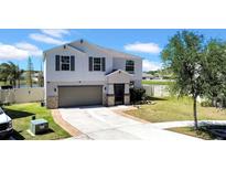 Charming two-story home with a well-maintained lawn, attached two-car garage, and classic design at 10612 Strawberry Tetra Dr, Riverview, FL 33578