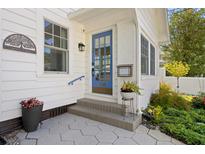 Inviting front entry featuring a blue door, brick accents and manicured landscaping at 1617 Oak Ne St, St Petersburg, FL 33704