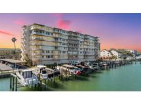 Multi-story waterfront condo with boat docks, parking, and balconies offering beautiful views at 223 Island Way # 2C, Clearwater Beach, FL 33767
