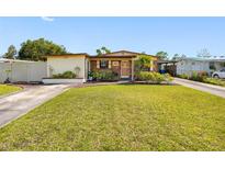 Charming single-story home with lush green lawn and well-maintained landscaping at 4532 W Idlewild Ave, Tampa, FL 33614