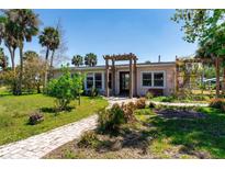 Charming single-story home featuring a landscaped front yard and inviting walkway leading to the entrance at 112 Gause Dr, Venice, FL 34293