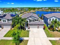 Beautiful home with a three-car garage, stunning lake view, community pool, and solar panels at 11416 Carlton Fields Dr, Riverview, FL 33579