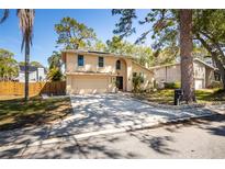 Captivating exterior of a two-story home featuring a driveway, two-car garage, and mature landscaping at 14323 83Rd Pl, Seminole, FL 33776