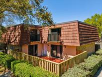 Charming two-story townhouse with a cozy fenced patio and upper level balconies at 2644 2Nd Ct, Palm Harbor, FL 34684