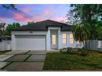 Charming single-Gathering home with modern design, well-manicured lawn, and inviting curb appeal at 3422 E Powhatan Ave, Tampa, FL 33610