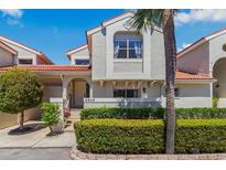 Charming two-story townhome featuring a terra cotta roof and manicured landscaping at 4859 Napoli Ne Ct # 4859, St Petersburg, FL 33703