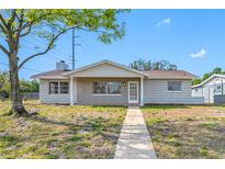 Charming single-story home featuring a cozy brick entryway and a well-maintained front yard at 5200 52Nd N Ave, St Petersburg, FL 33709