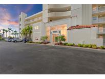 A view of the front of a building with palm trees in the parking lot and a sidewalk in front at 6021 Bahia Del Mar Cir # 137, St Petersburg, FL 33715