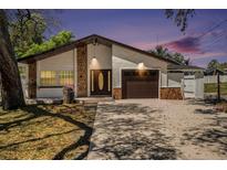 Charming single-story home with stone accents, a two-car garage, and a well-maintained front yard at 8902 N Hamner Ave, Tampa, FL 33604