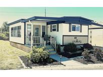 Charming single-story home with a covered front porch, landscaped yard and carport at 9790 66Th N St # 346, Pinellas Park, FL 33782