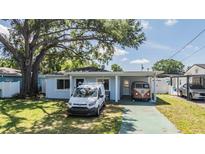 Charming single-story home featuring well-maintained landscaping and a spacious driveway at 2808 W Lake Ave, Tampa, FL 33607
