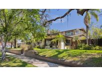 A charming home showcases lush landscaping, a well-maintained lawn, and a welcoming facade at 307 Bay St, Tarpon Springs, FL 34689