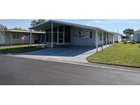 Single-story home with covered parking and manicured lawn at 3114 Briar St. St, Wesley Chapel, FL 33543