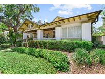 Charming home featuring well-manicured landscaping and a classic covered porch at 701 S Boulevard, Tampa, FL 33606