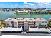 An attractive aerial view of The Sarasota complex with waterfront views and covered parking at 7645 Sun Island S Dr # 204, South Pasadena, FL 33707