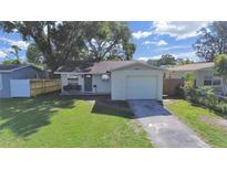 Charming single-story home with a well-manicured lawn and an attached garage at 7919 64Th N St, Pinellas Park, FL 33781