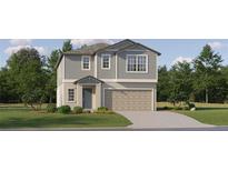 Charming two-story home with gray siding, landscaped yard, and a two-car garage at 9411 Raised Tulip Ln, Land O Lakes, FL 34637