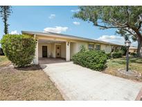 Charming single-story home with a covered entrance and well-maintained landscaping at 1218 Haddington Cir, Sun City Center, FL 33573